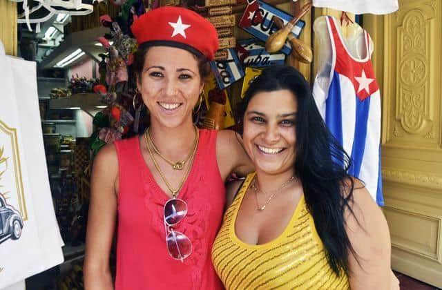 turismo_en_cuba_-dos-mujeres-sonríen-en-La-Habana-Cuba-bandera-cubana-economía-negocios.jpg